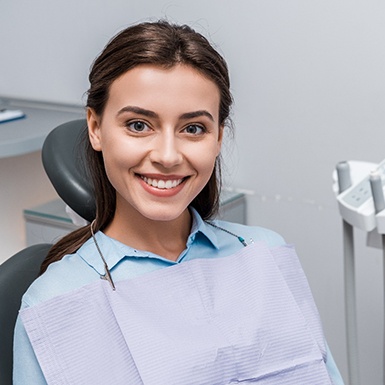 Smiling female patient glad she could afford dental implants