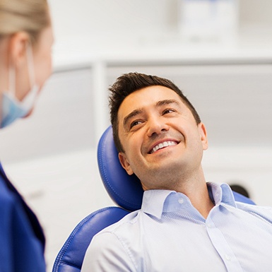 patient smiling with permanent implant dentures in Philadelphia