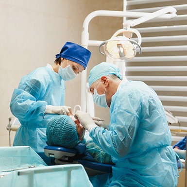 A dentist performing dental implant surgery