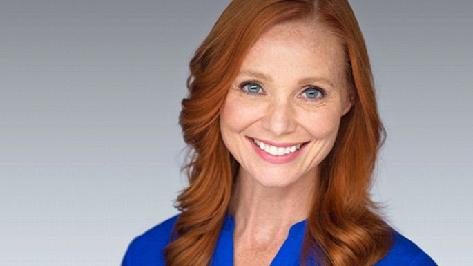 Smiling, middle-aged woman enjoying the benefits of All-on-4 treatment