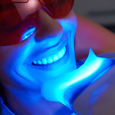 A woman receiving in-office teeth whitening