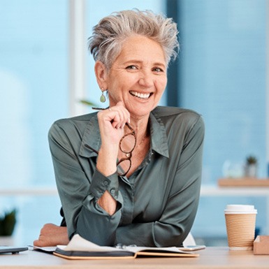 Woman smiling at a desk