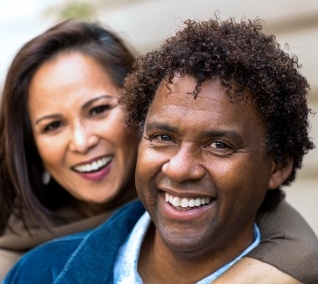 Man and woman smiling together outdoors