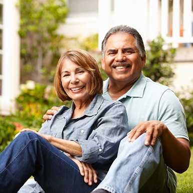 Older couple with dental implants in Philadelphia sitting outside