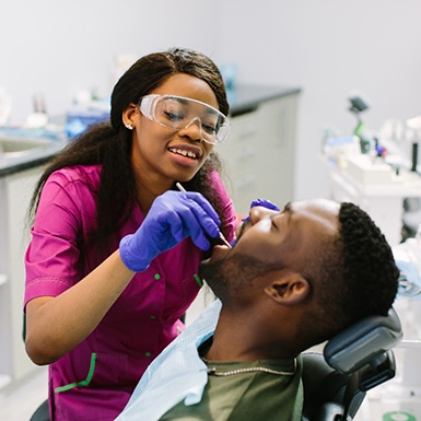 Dentist performing dental implant care in Philadelphia