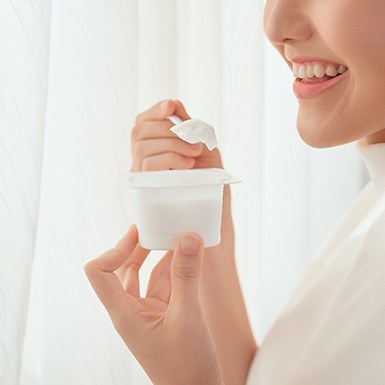 closeup of woman eating yogurt 