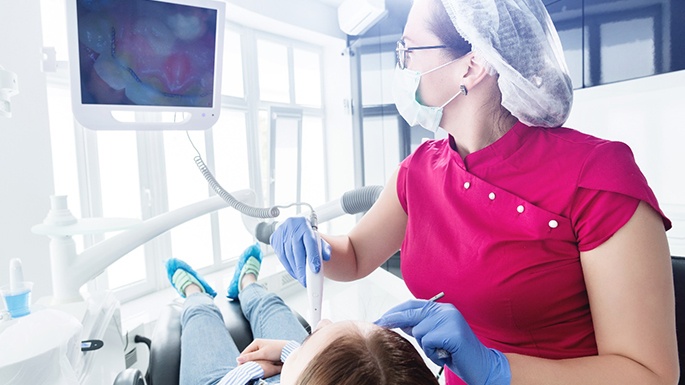 Intraoral camera being used during female patient’s exam