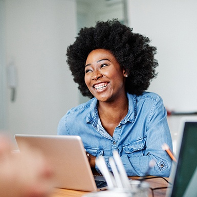 Woman smiling during work meeting in office