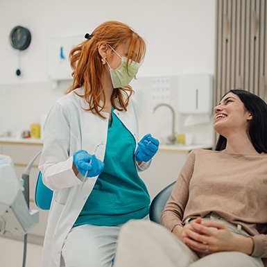 Smiling patient talking to dentist in treatment chair
