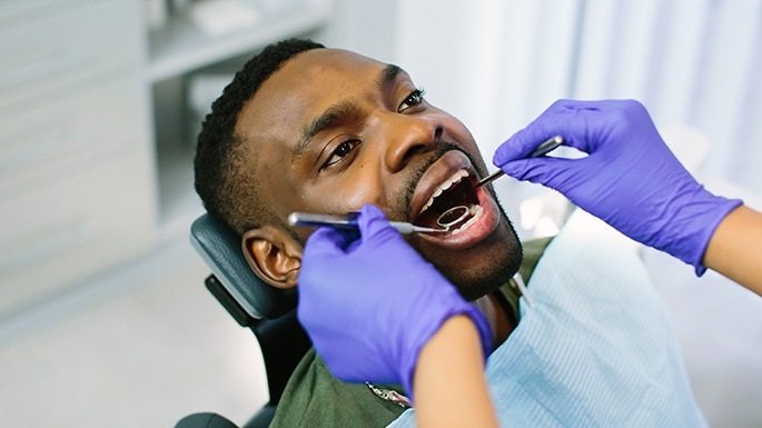 Man receiving one visit dental restoration treatment