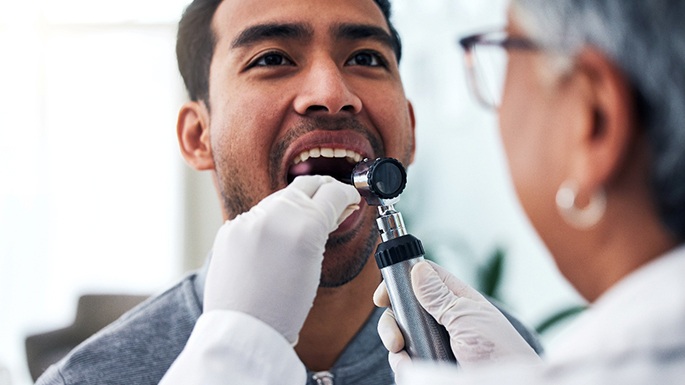 Dentist examining a patient’s mouth