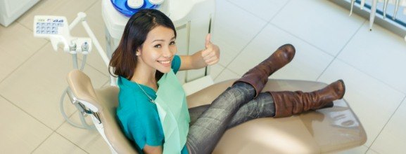 Woman giving thumbs up after preventive dentistry visit