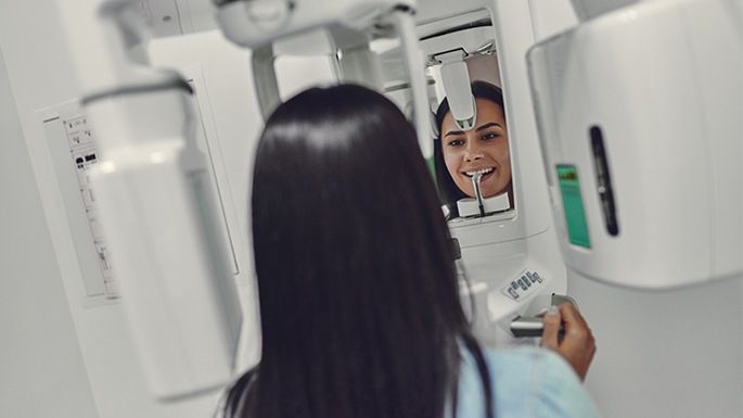 Patient receiving 3 D cone beam imaging scans