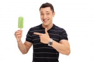 Man using popsicle to ease Invisalign discomfort in Bustleton