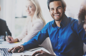 Successful man smiling in business meeting with partners