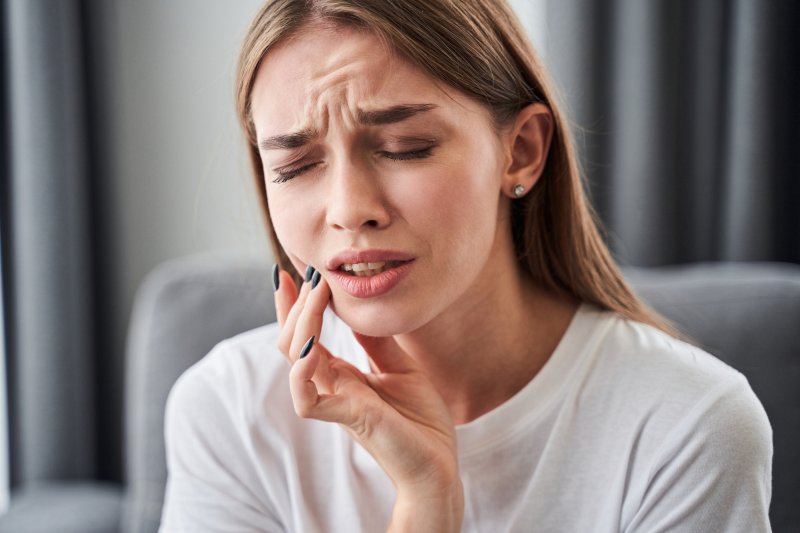 woman with injured tooth needing an emergency dentist in Philadelphia 