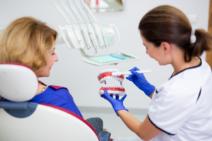 a patient visiting their dentist to receive dentures