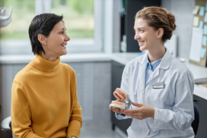 a patient visiting her dentist to receive dentures