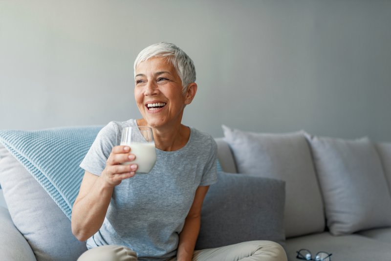 older woman drinking a glass of milk