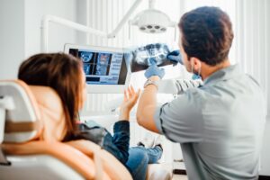 Dentist showing patient an X-ray.
