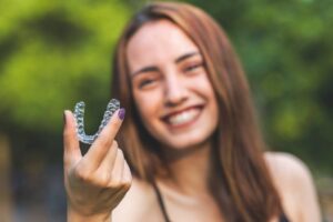 Woman smiling while first starting her Invisalign treatment