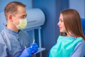 young woman talking with her dentist