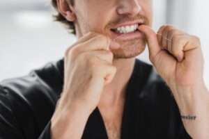 Man flossing his teeth