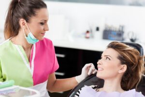Dentist visiting with patient.